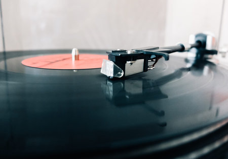 Close-up of a cartridge head on a vinyl record, analog retro music, vinyl disc collecting, vintage...