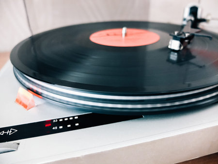 Close-up of a cartridge head on a vinyl record, analog retro music, vinyl disc collecting, vintage...