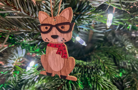 A close-up of a wooden toy on a Christmas treeの写真素材