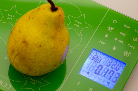 Ripe sweet pear on the scalesの写真素材