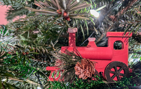 A close-up of a New Year's wooden toy on a Christmas tree