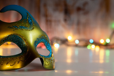 New Year's Eve mask against the background of Christmas garland lights. New Year party still life imagesの写真素材