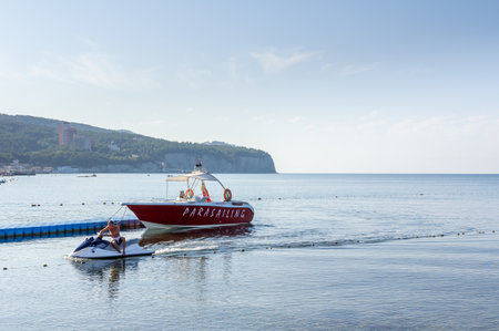 A sea boat and jet skis are moored at the sea pier.の写真素材