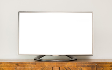 Flat LCD television on brown wooden cabinet in the living room with a white screen for copy textの写真素材