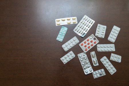 Packaging of tablets and pills on the table. Drug prescription for treatment medication. Pharmaceutical medicament, cure in container for health. Antibiotic, painkiller closeupの写真素材