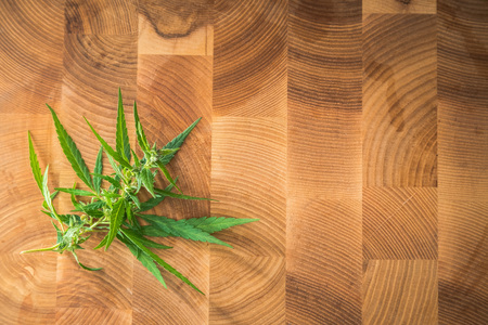 Macro photos of marijuana plant with leaves and buds on wooden background. The cannabis plant close up view. Plant of marijuana medical use with a high content of CBDの写真素材