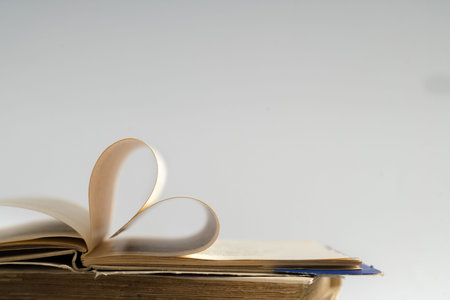 Old hard cover book page decorate to heart shape for love in valentine day with blurred background...