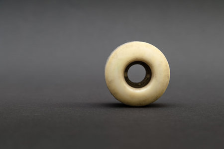 Close up of a skateboard wheel on black background. Complete skateboard parts