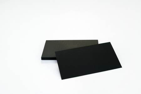 Photo of black blank business cards on a white background. Template for ID. Top viewの写真素材