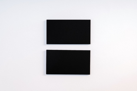 Photo of black blank business cards on a white background. Template for ID. Top viewの写真素材