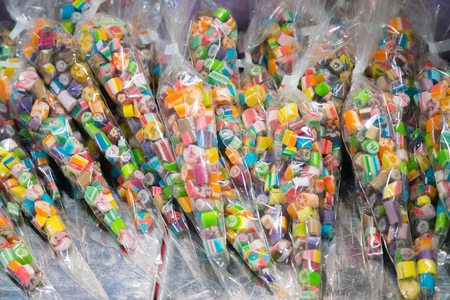 Many assorted sweet sugar candies on display in the candy storeの写真素材