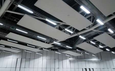 Factory building or warehouse building. Vast empty space with ventilation pipes and lightsの写真素材