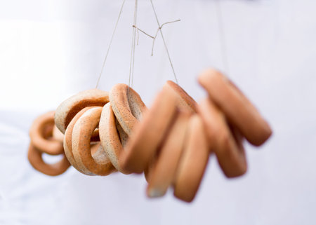 Ring-shaped rolls in a fare for sale on white background, bagels, bread ringの写真素材