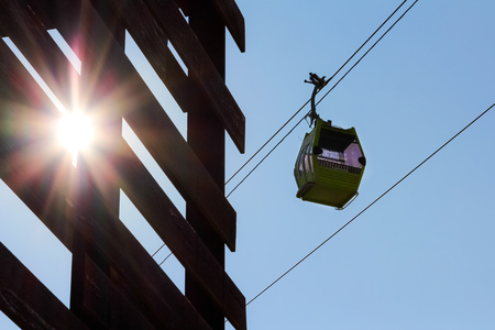funicular on the line isolated in blue sky with sun shining on the sideの写真素材