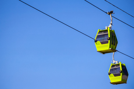 Funicular on the line isolated in blue sky with sun shining on the sideの写真素材