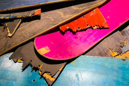 Broken colorful skateboard decks stacked on top of each other, skateboard recyclingの写真素材