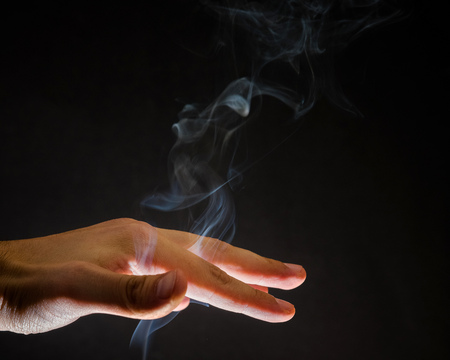 Smoke rising up through human hand. Spirits, spiritual background, witchcraftの写真素材