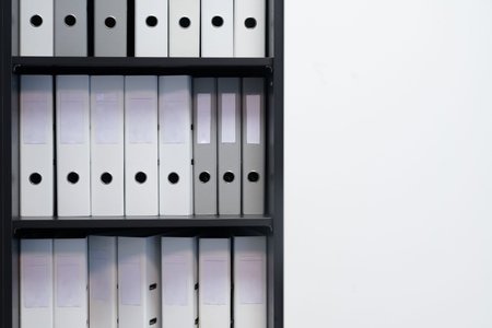Blank blind folders with files in the shelf. Archival, stacks of documents in the book at the office...