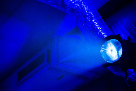 Bright blue light at the underground parking garage with ventilation pipes at backgroundの写真素材