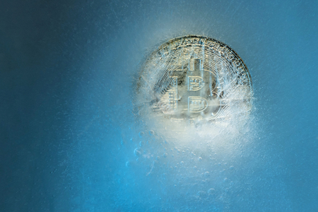 Silver Bitcoin, bit coin online digital currency frozen in the blue ice. Concept of block chain, crypto market crash. Frozen crypto money, depreciationの写真素材