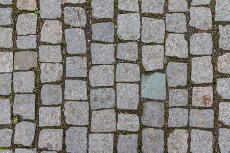 Old cobblestone tile texture in old town. City pavement background. Abstract granite stone brick pattern. Street sidewalk textureの写真素材
