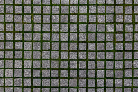 Old cobblestone tile texture in old town. City pavement background. Abstract granite stone brick pattern. Street sidewalk textureの写真素材