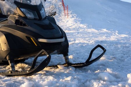 Snowdrift snowmobile on snow in ski resort. Off road vehicle with sleds outdoorsの写真素材