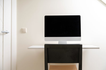 Computer with blank screen on the desk at home office. Working from home, isolation. Nobody