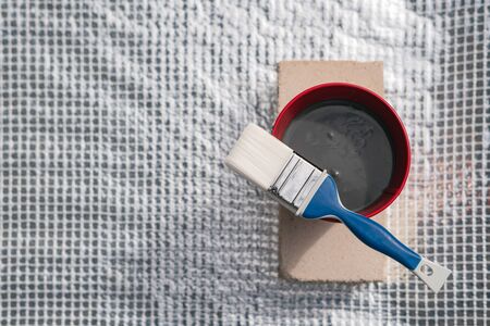 Paint brush and a bucket with paint still life. Painting house outside. Home renovation. Nobodyの写真素材