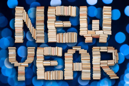 New Year text on abstract blue bokeh balls background. Holiday letters on festive backgroundの写真素材