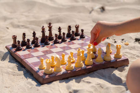 Chess play on the board at the beach. Chessboard on the sand on a sunny day.の写真素材