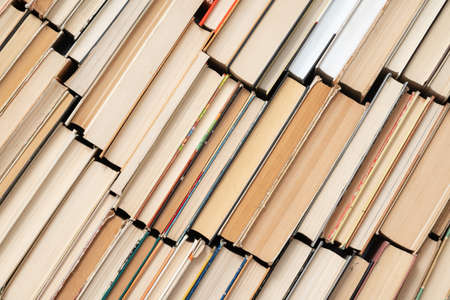 Vintage book background. Old and used hardback books stacked next to each other. Concept of education and studying. Nobodyの写真素材