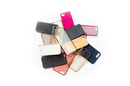 Pile of multicolored plastic back covers for mobile phones on white backgroundの写真素材