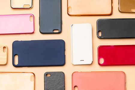 Pile of multicolored plastic back covers for mobile phone. Choice of smart phone protector accessories on neutral background. A lot of silicone phone backs or skins next to each otherの写真素材