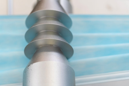 Closeup process of medical face masks being made in a factory. Automated machinery making...