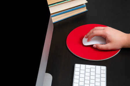 Close up of hands typing keyboard and using mouse at the office. Concept of education and working on computer.の写真素材