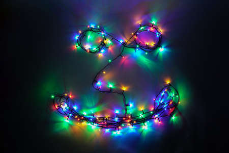 Happy face decorated of colorful Christmas lights on black backgroundの写真素材