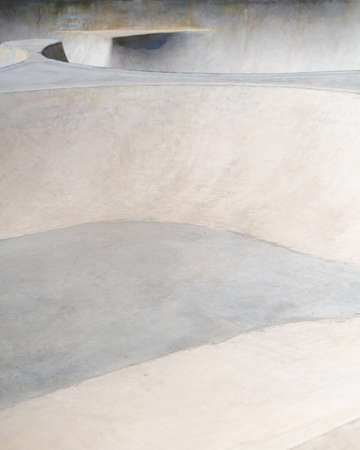 Concrete public skate park on a sunny day. Cement ramps for skateboarding and bmx. Extreme sportの写真素材