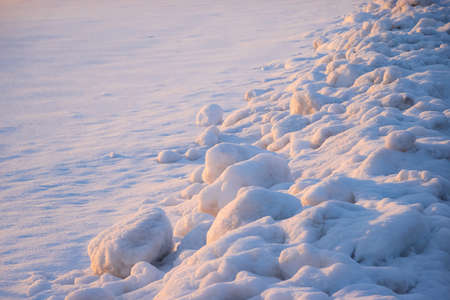 Cleaned snow on the side of the sidewalk. Winter weather background. Nobodyの写真素材