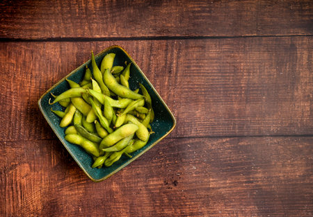 Edamamen Boiled green soybeans in a bowl on a wooden background.の写真素材