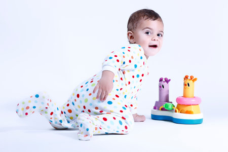 Happy kid playing toys isolated on white background and smilingの写真素材