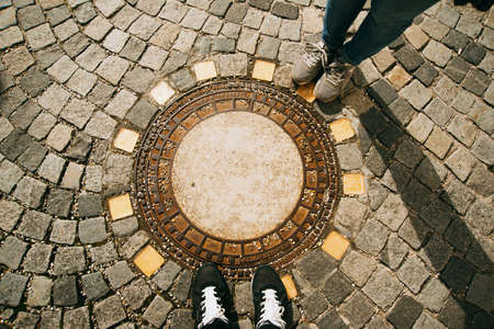 Austria/ Melk, 8 march 2020 photo of old pavement and rusty sewer hatch on an old metal plateのeditorial素材