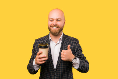 A photo of a businessman holding a cup of coffee smiling