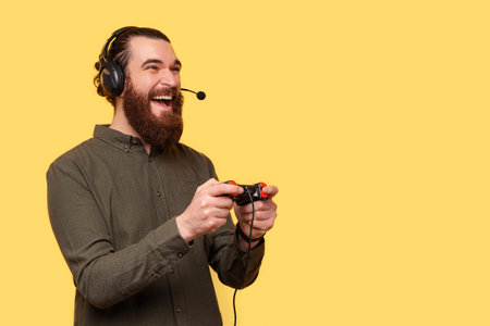 A photo of an excited man playing with his new console a video game