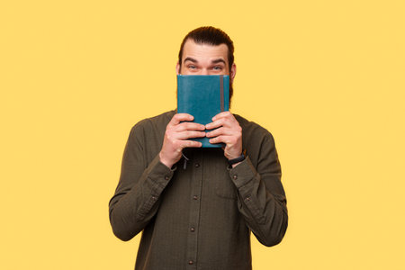 A picture of a man excitingly holding a planner near himの写真素材
