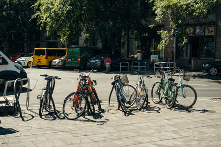 Hungary, Budapest. 15 JUNE 2022. A row of some parked bicycles on streets of Budapest city on a summer sunny day.のeditorial素材