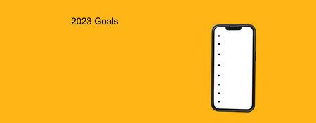 Yellow banner shot of a big phone with empty to do list for 2023 goals.