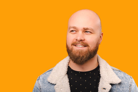 Close up portrait of young cheerful and handsome bearded hipster man