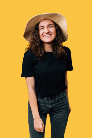 Vertical studio portrait of a cheerful smiling woman wearing a sun hat.の写真素材