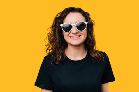 Close-Up of Young Happy Woman Wearing Sunglasses - Studio Shot.の写真素材